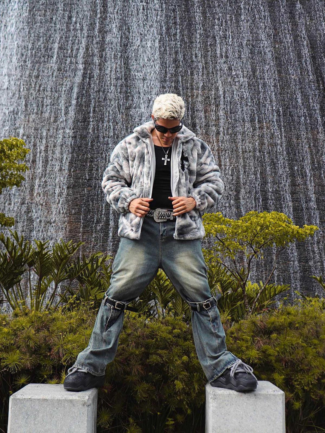 TALISHKO urban jacket in tie-dye faux lambswool, styled boldly in front of a waterfall backdrop.