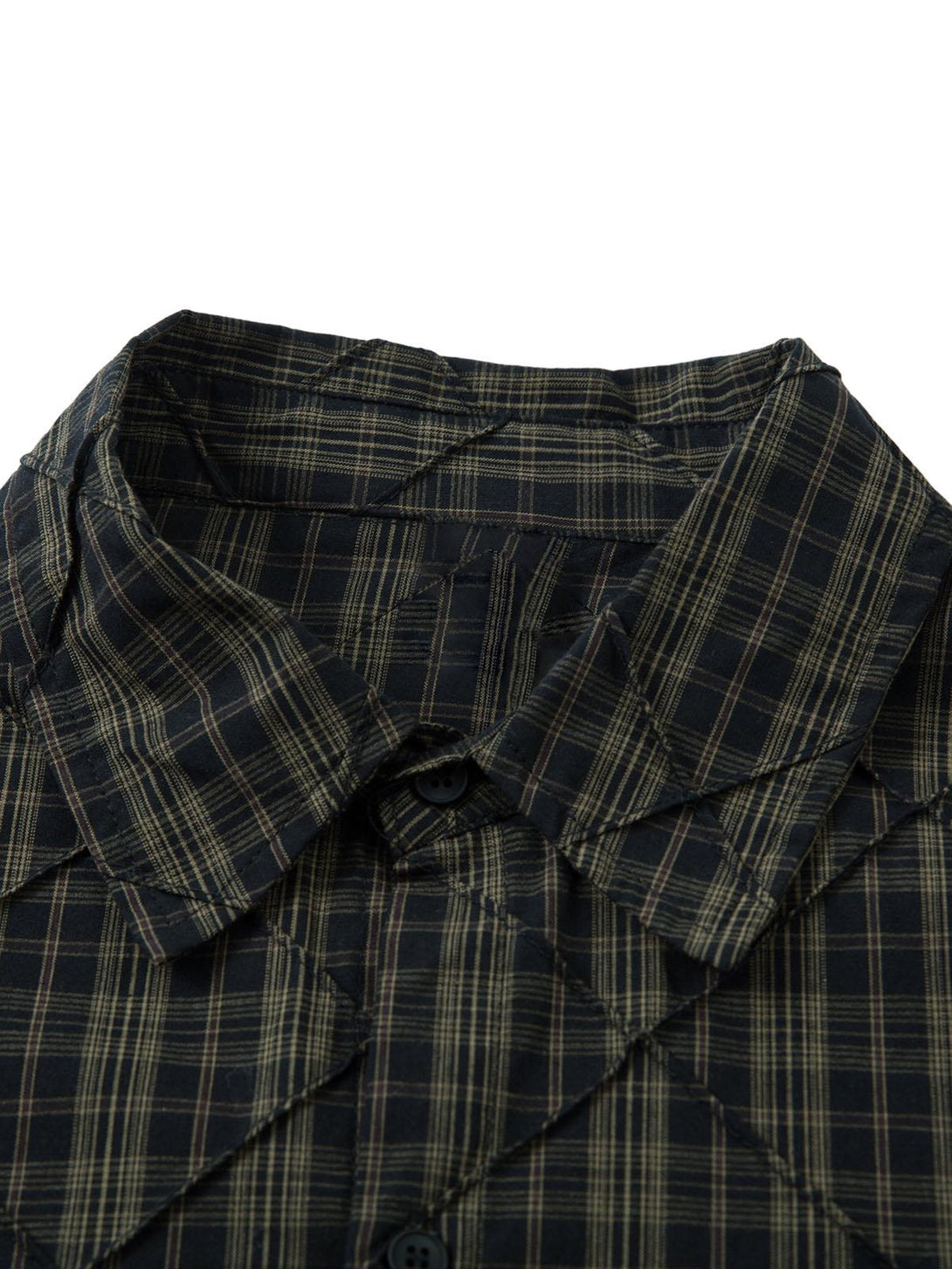 A detailed view of the plaid fabric and pleated design of the TALISHKO polo shirt.