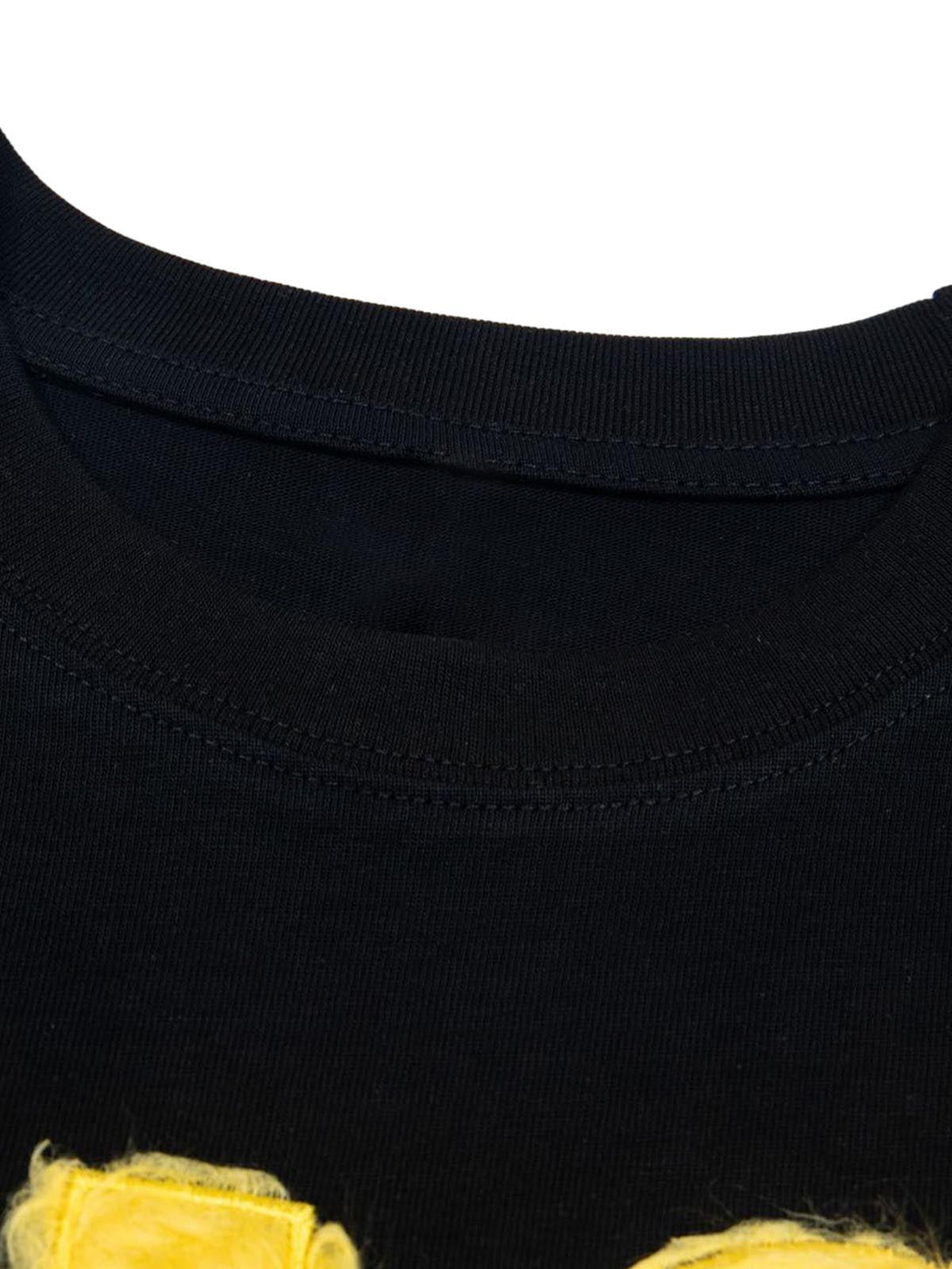 Detailed view of black TALISHKO T-shirt collar, highlighting retro-inspired yellow embroidery.