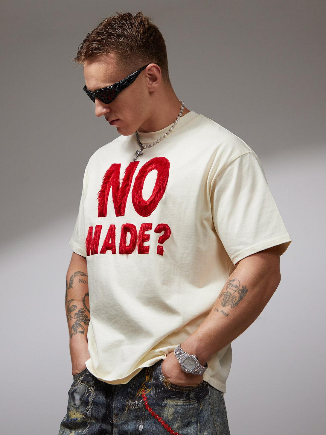 Model in a TALISHKO T-shirt with textured red embroidery, highlighting a bold, retro flair.