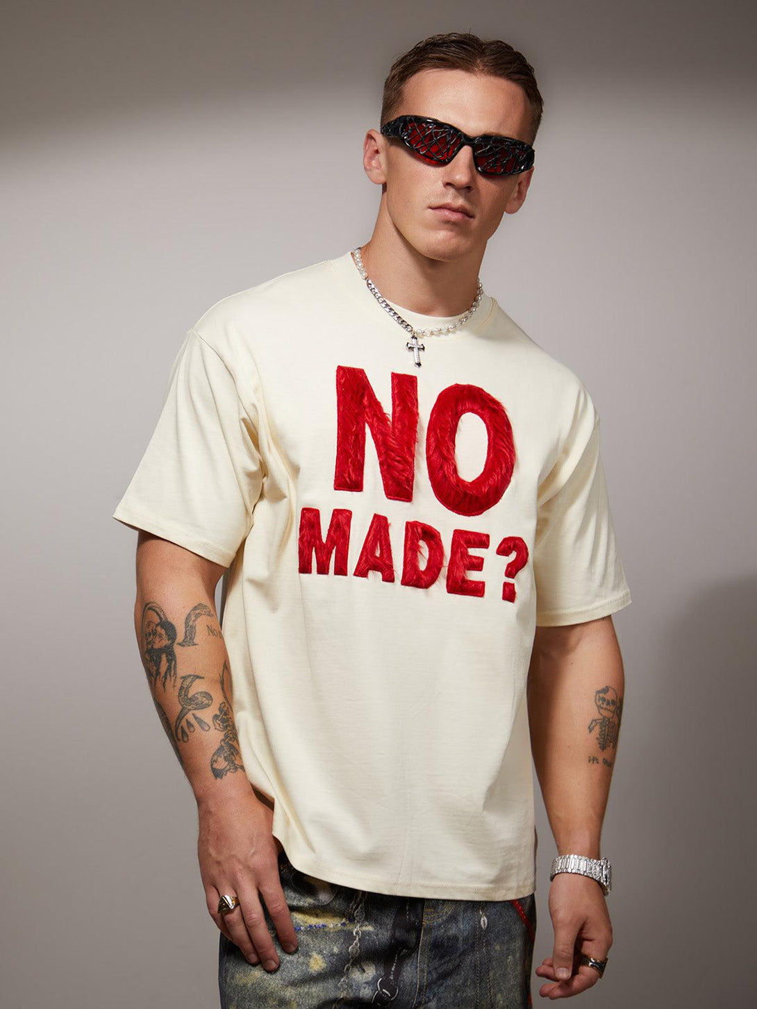 Model in TALISHKO T-shirt with striking red embroidery, embodying a bold retro style.