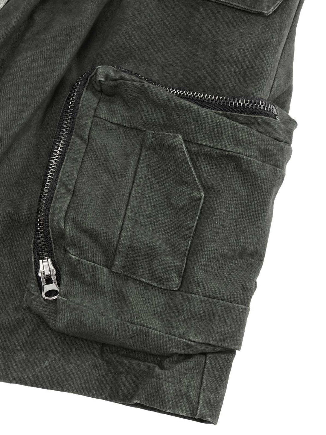 A detailed look at TALISHKO's washed shorts, highlighting the multi-pocket design and zipper.