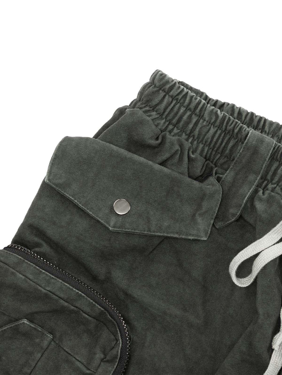 TALISHKO shorts detail view highlighting the washed fabric, elastic waistband, and pocket design.