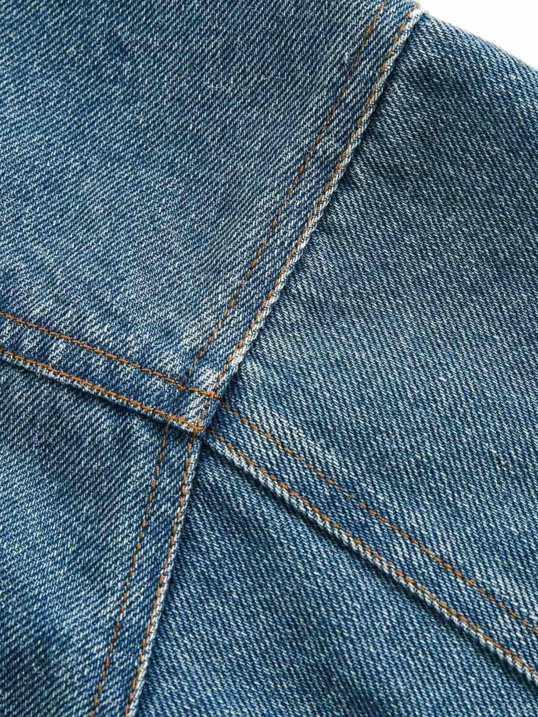 Detailed fabric and stitching on TALISHKO's denim work jacket, highlighting its craftsmanship.