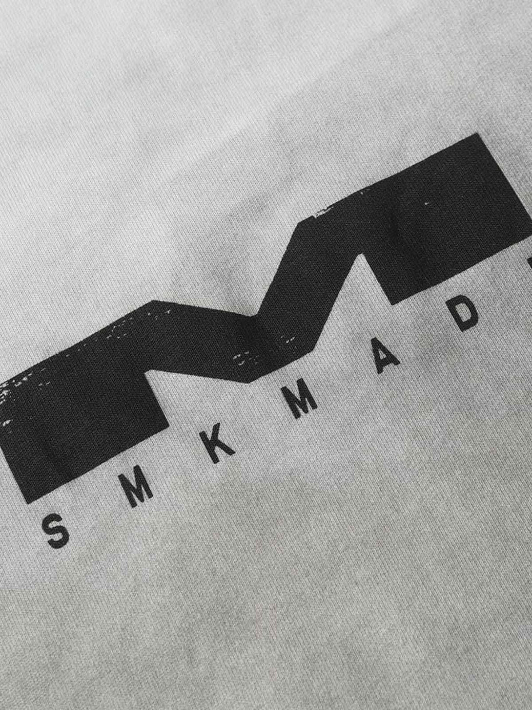 A detailed look at the TALISHKO T-shirt's distressed print, highlighting its textured design.