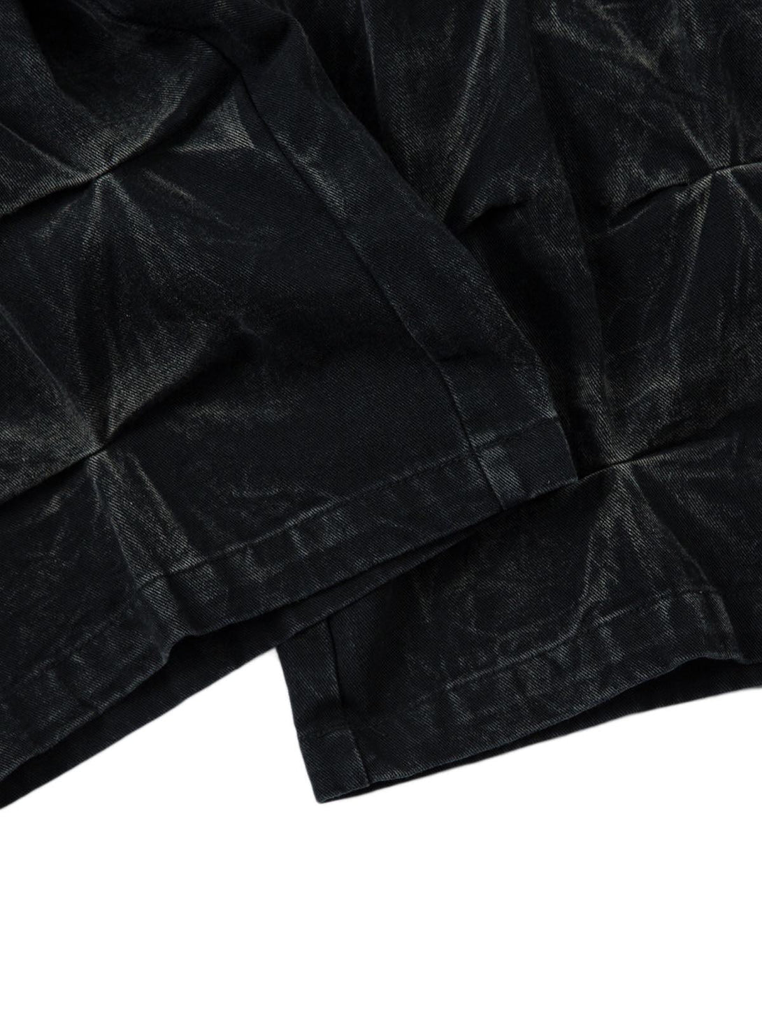 A detailed view of TALISHKO's distressed pleated texture on heavy washed fabric.