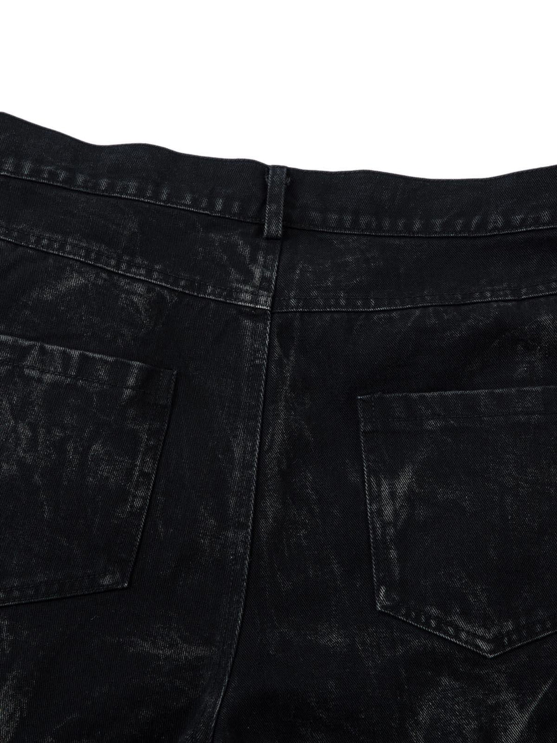 Back view of TALISHKO jeans highlighting the heavy washed and distressed texture.