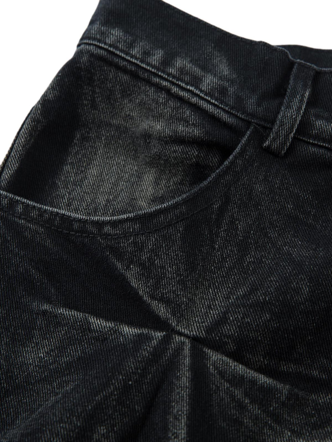 Intricate look at TALISHKO jeans, showcasing the heavy washed, distressed texture and pleats.
