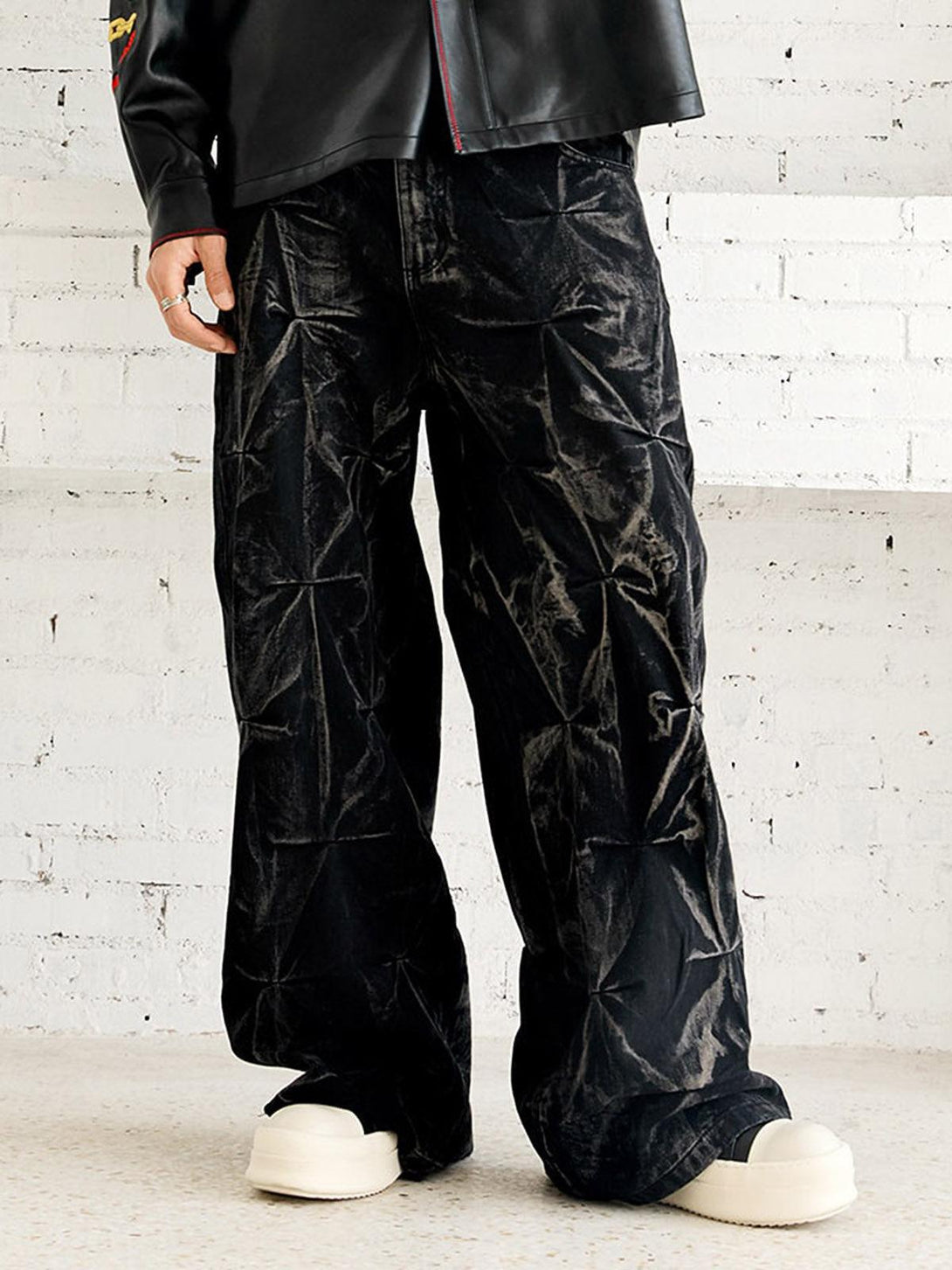 TALISHKO baggy jeans with a heavy washed, distressed pleated design worn by a model.