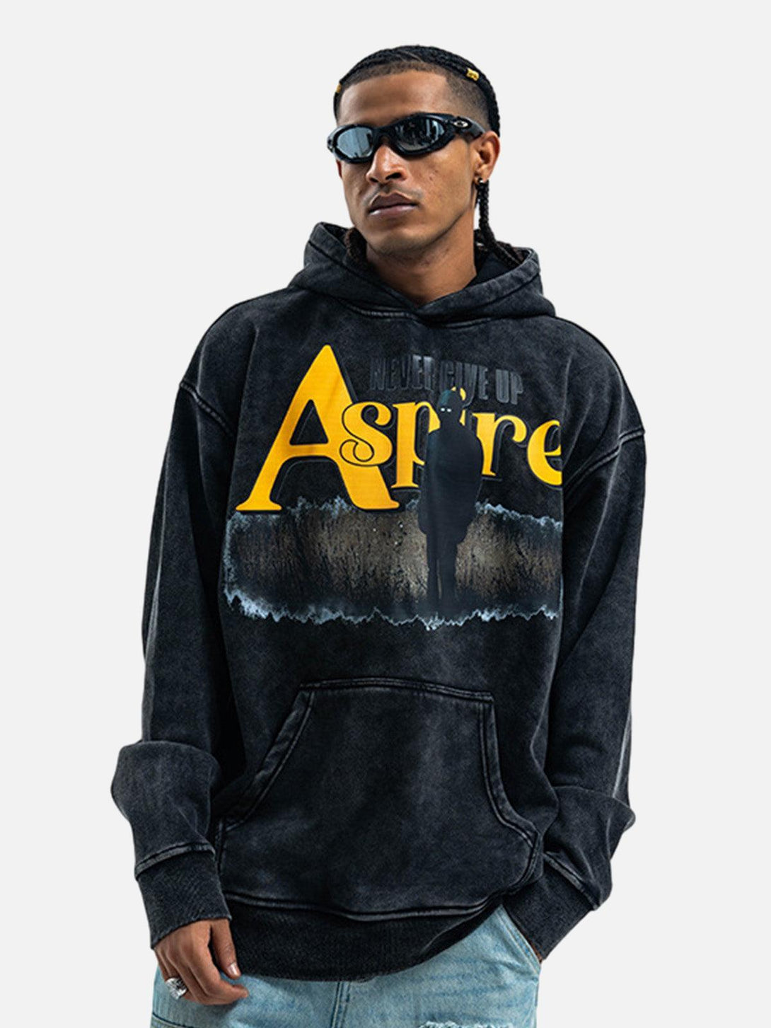 Model in TALISHKO hoodie with bold yellow "Aspire" print, offering a trendy streetwear vibe.
