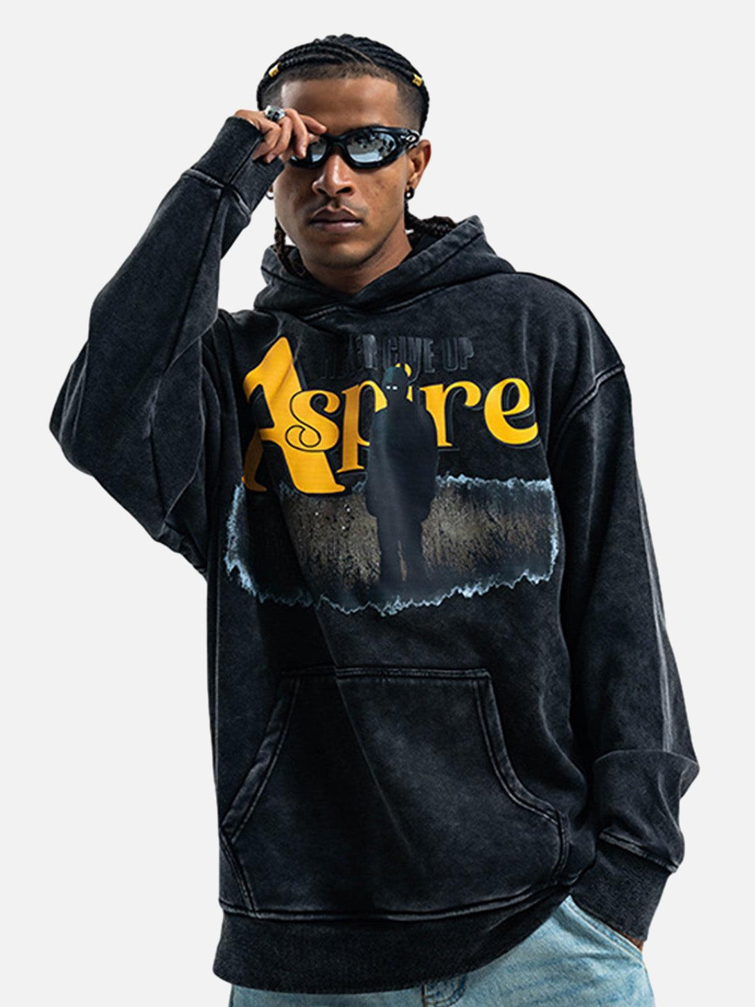 Model showcasing a TALISHKO hoodie with bold "Aspire" print, capturing a trendy street look.