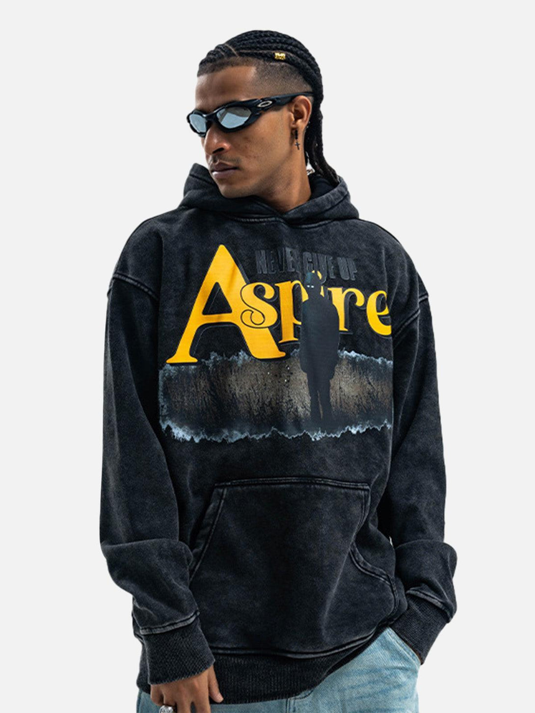 Model wearing a TALISHKO fleece hoodie with "Aspire" print, showcasing streetwear style.