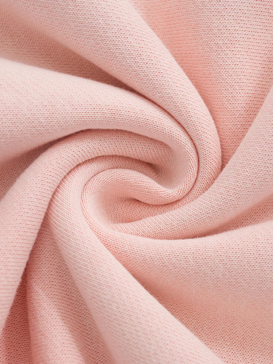 Soft pink fabric texture of TALISHKO hoodie, highlighting the intricate knit and smooth finish.