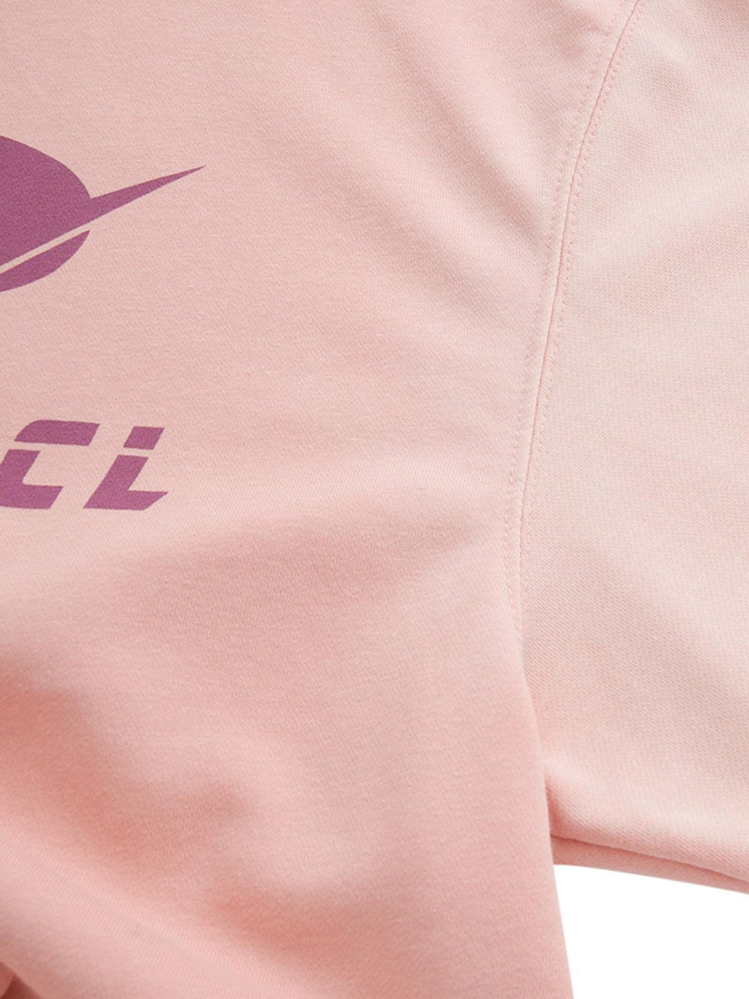 Close-up view of TALISHKO hoodie fabric, highlighting bold purple graphics on soft pink material.