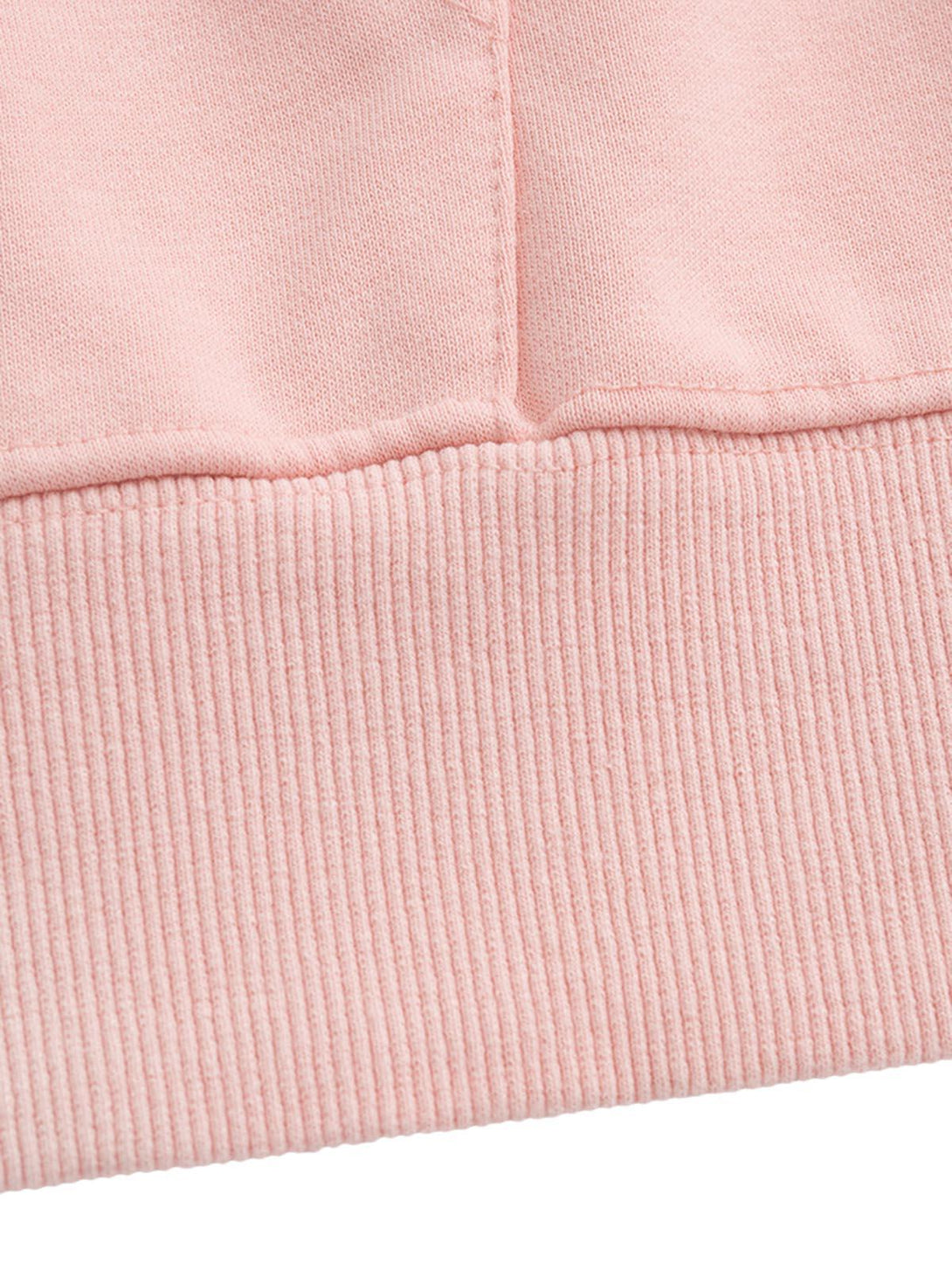 A detailed view of the TALISHKO hoodie's hem, showcasing the soft pink ribbed texture.