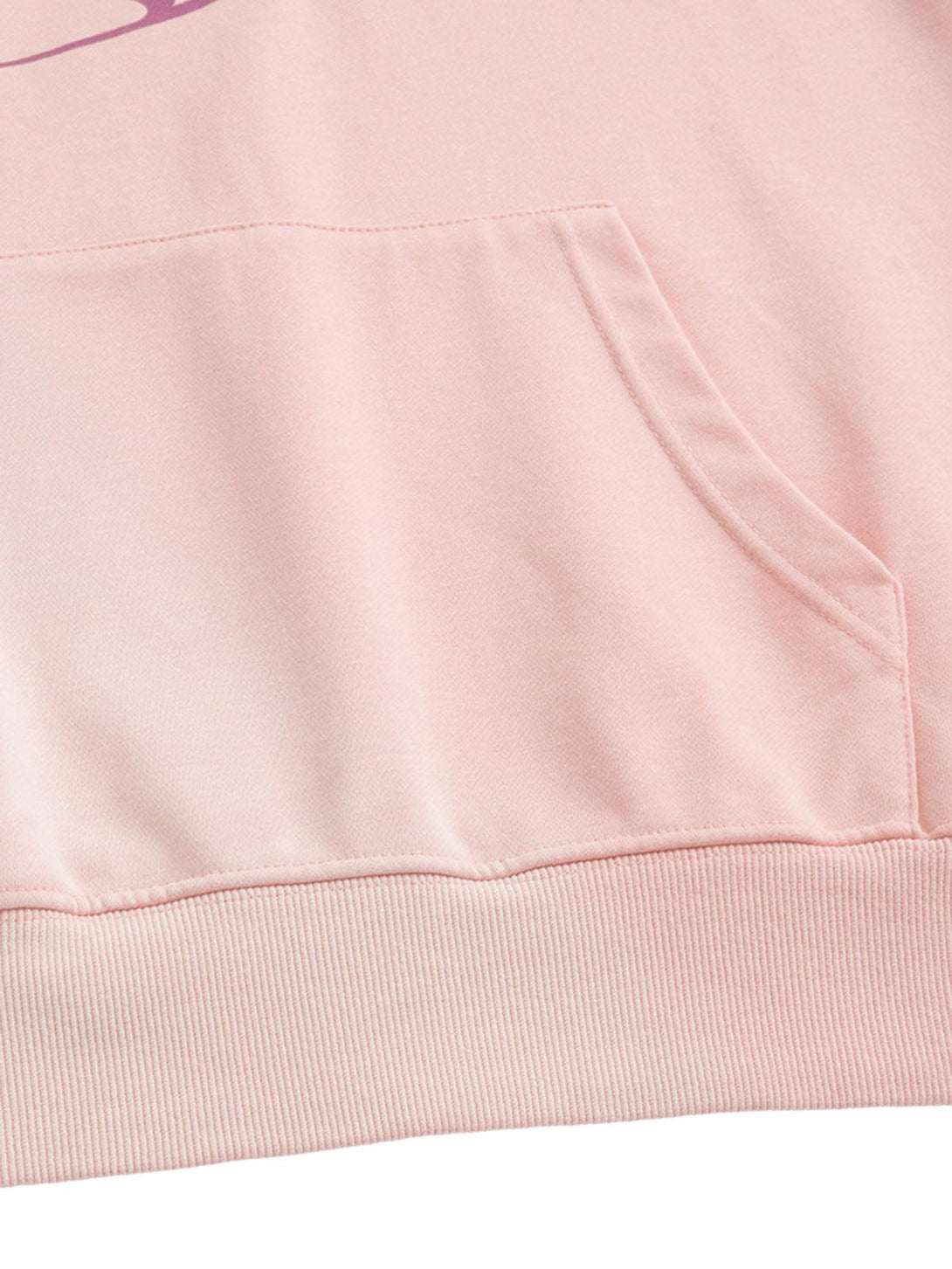 A detailed view of TALISHKO hoodie pocket, featuring soft pink fabric and precise stitching.