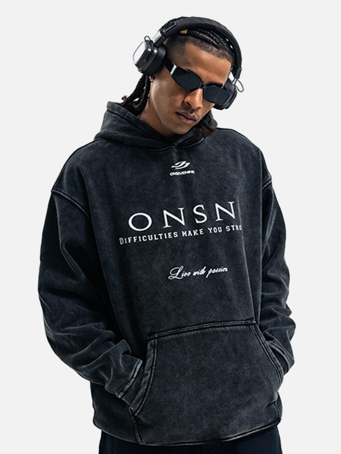 Model in TALISHKO heavy washed hoodie, styled with headphones and sunglasses for a modern vibe.
