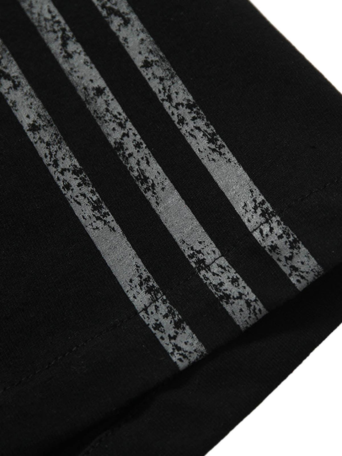 Focusing on the unique sporty stripes of a TALISHKO T-shirt, highlighting its stylish detail.