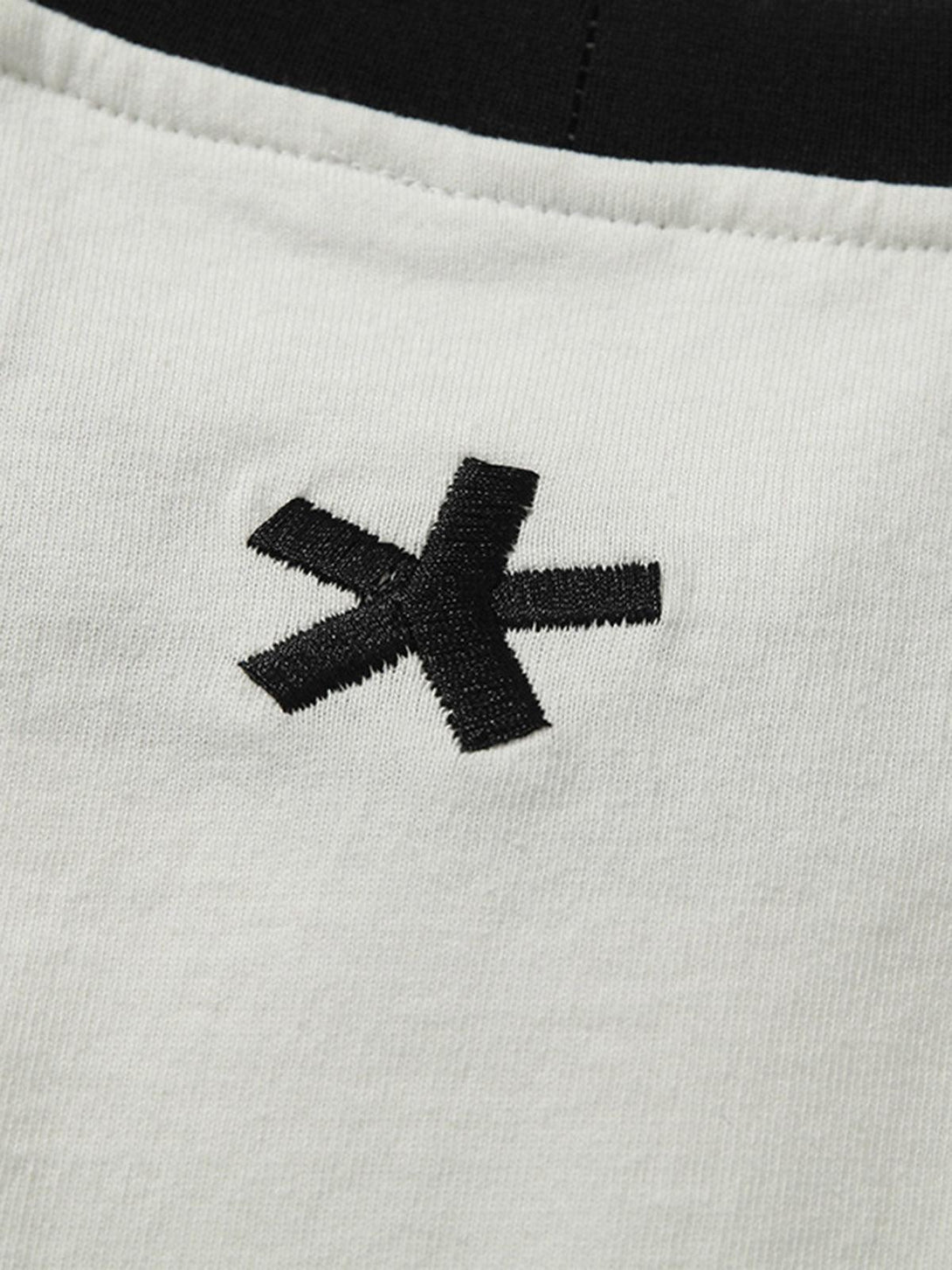 Detailed view of TALISHKO T-shirt's black asterisk logo on fabric, highlighting unique style.