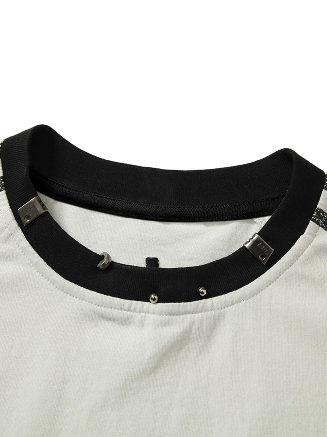 Detailed view of TALISHKO T-shirt's metal collar and stitching, showcasing unique craftsmanship.