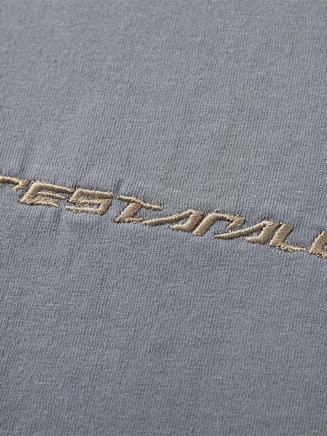 Intricate view of TALISHKO T-shirt showcasing detailed stitching and unique fabric texture.
