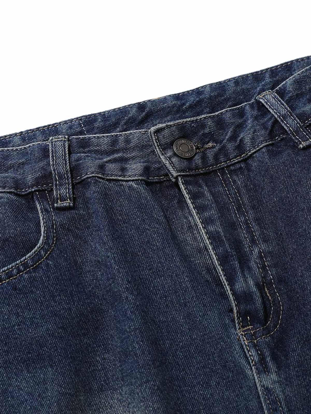 A detailed view of TALISHKO's heavy washed workwear jeans, highlighting sturdy stitching.