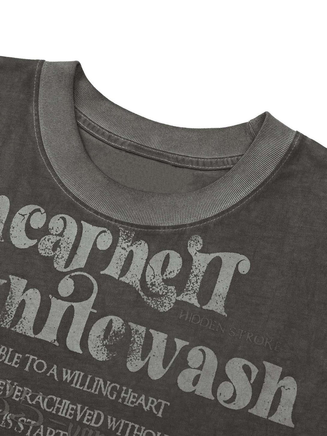 "Intricate look at TALISHKO's gray vest, highlighting retro typography and fabric detail."