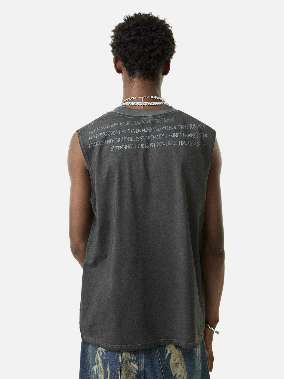 Back view of TALISHKO's washed gray vest with retro quotes, styled casually with denim.