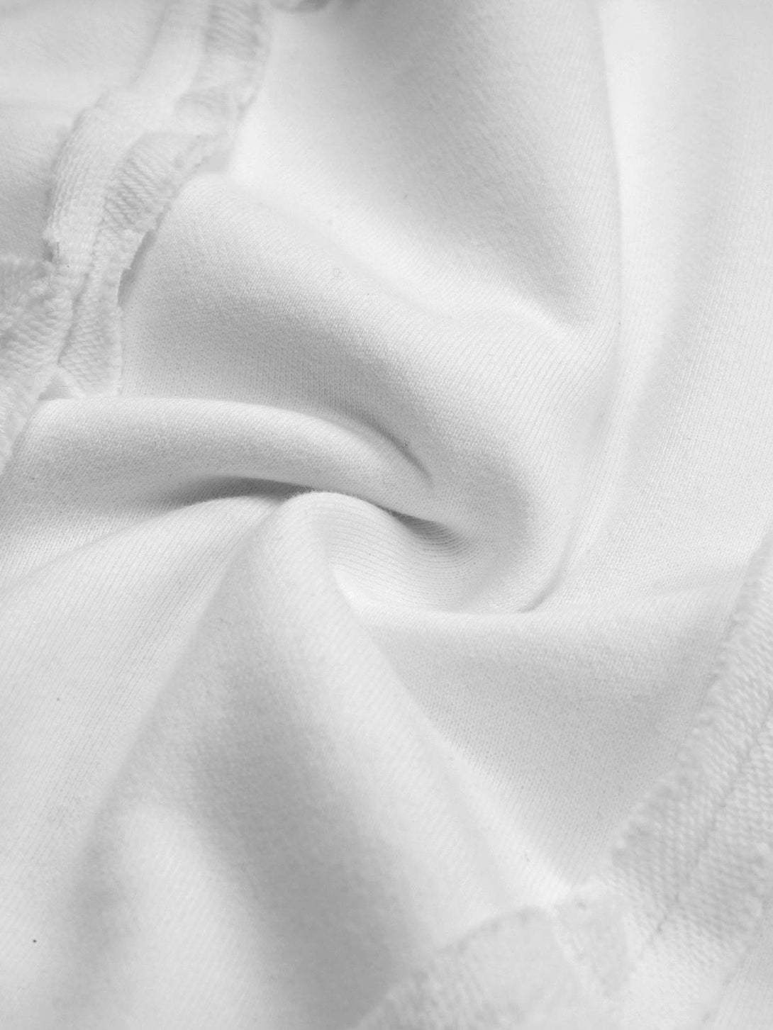 Intricate look at the textured fabric and stitching of a white hoodie by TALISHKO.