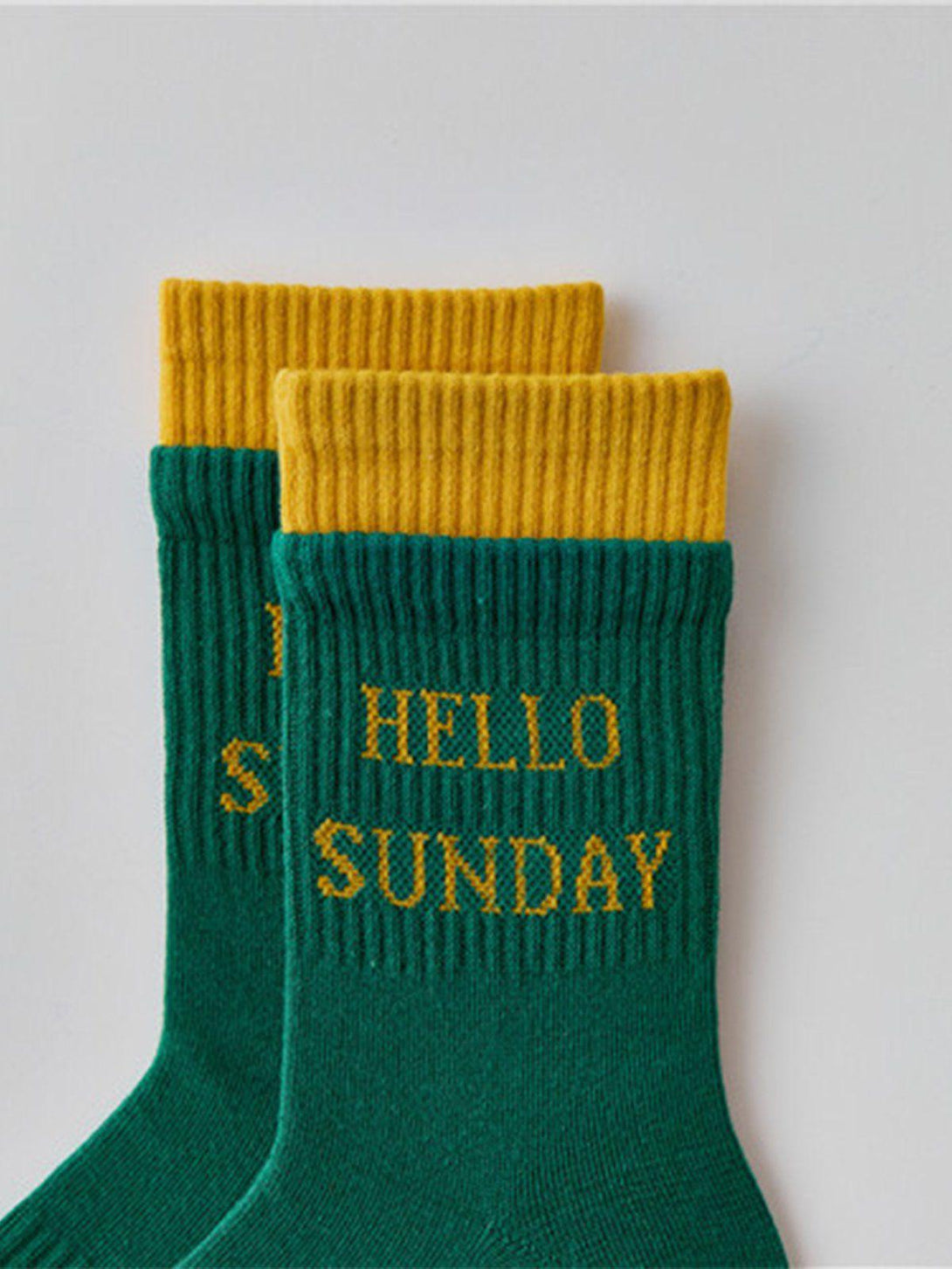 Green socks with yellow cuff and "HELLO SUNDAY" text by TALISHKO, perfect for cozy weekends.