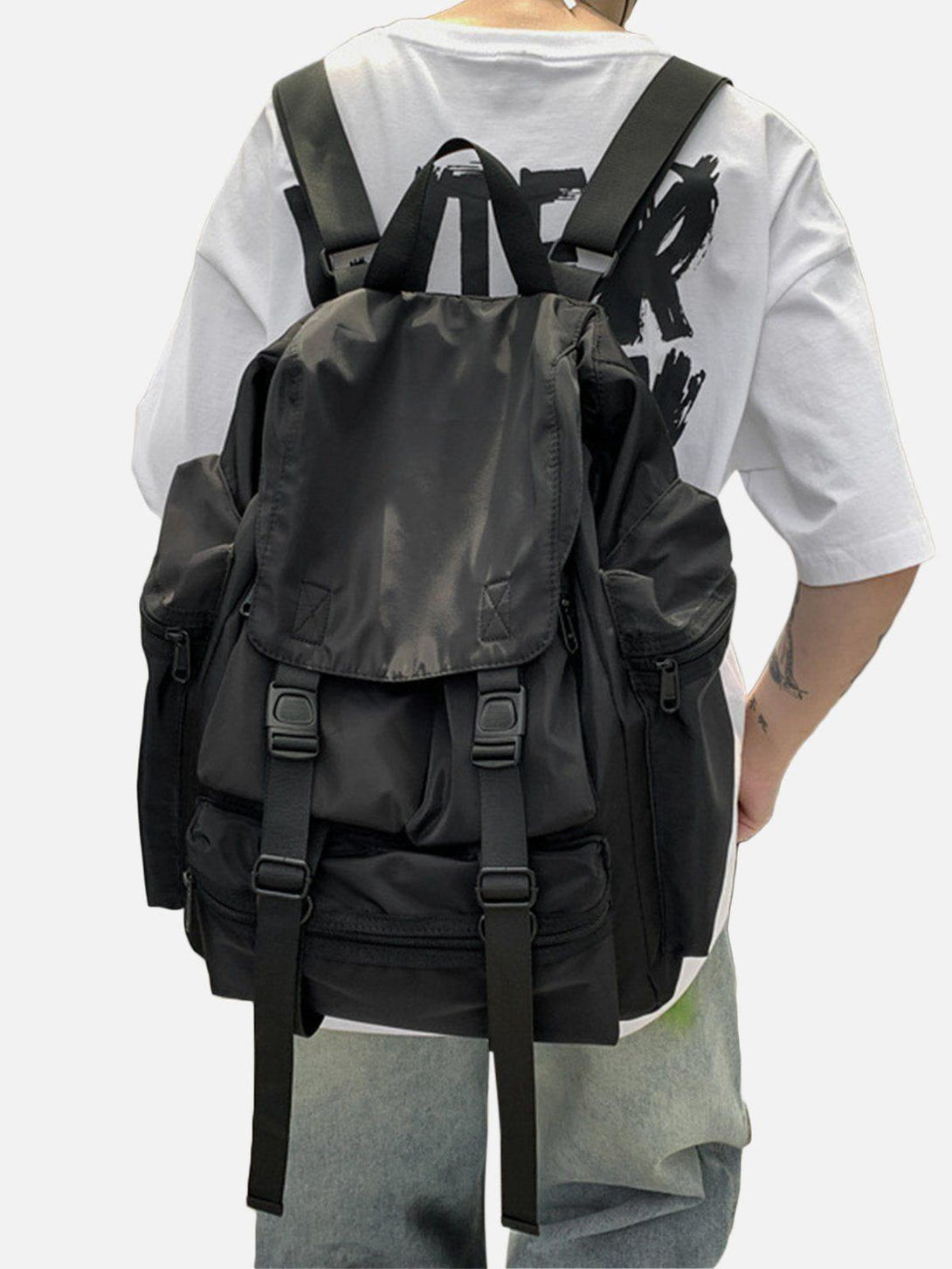 A versatile black high-capacity backpack by TALISHKO, worn casually over a graphic tee.