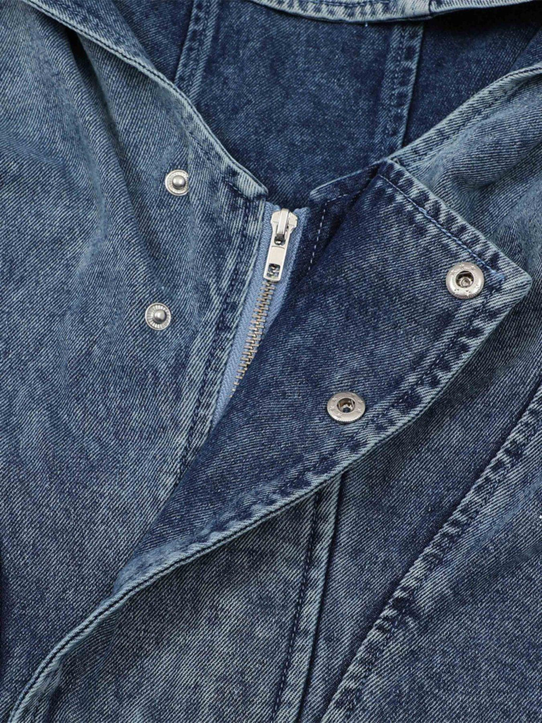Detailed view of TALISHKO's high-neck hooded denim jacket, featuring button and zipper details.