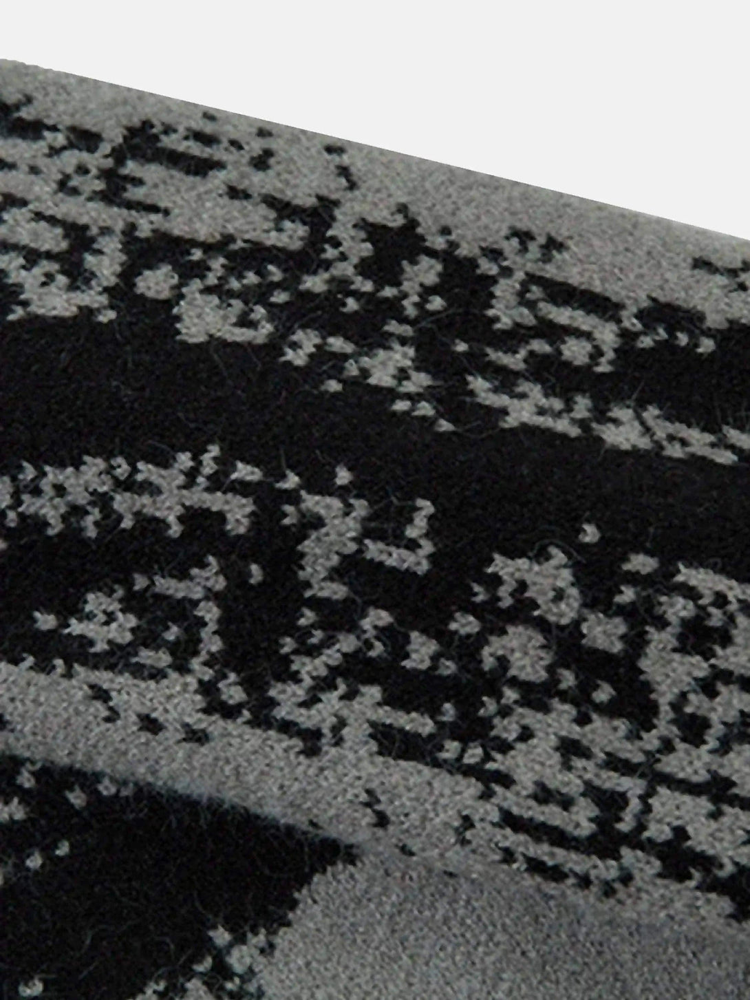 Zoomed-in texture of TALISHKO cardigan, showcasing intricate abstract pattern details.