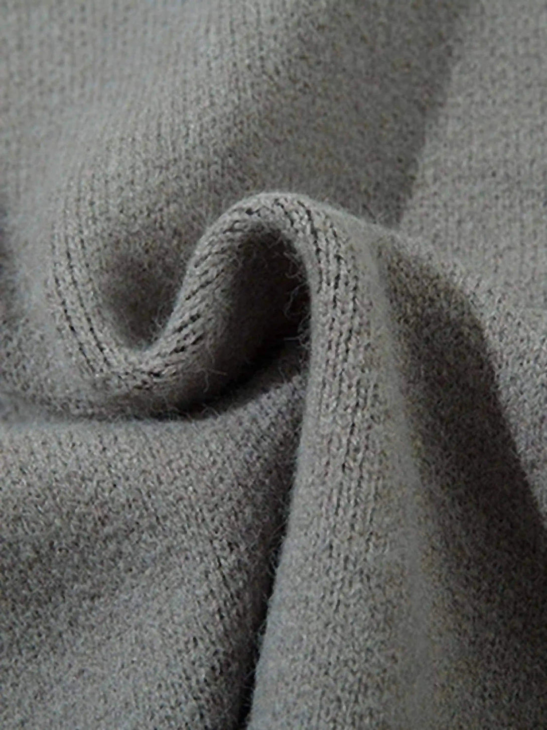 Intricate look at the TALISHKO cardigan's textured fabric, showcasing its abstract design.