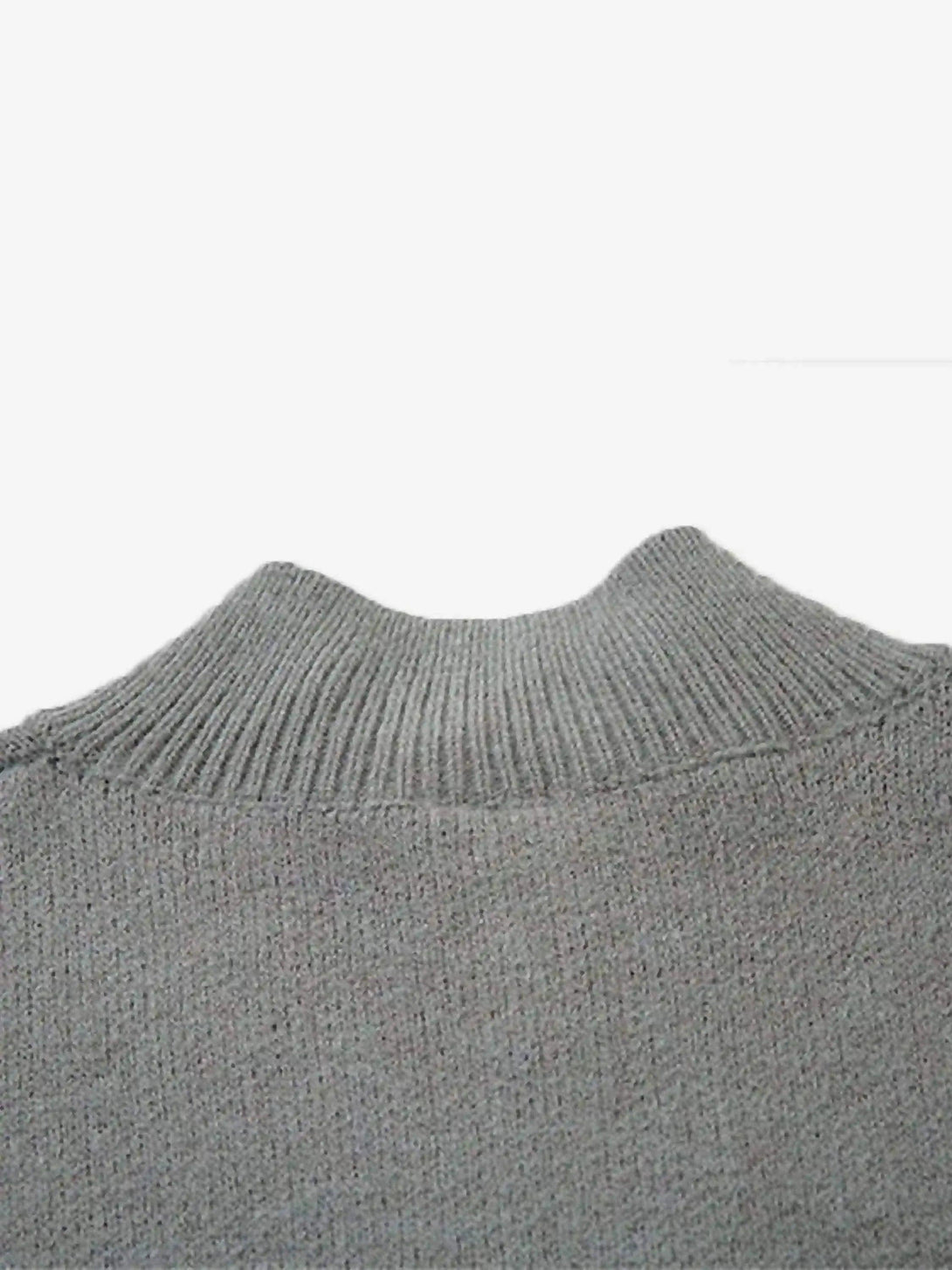 A detailed look at the TALISHKO cardigan's ribbed stand collar, showcasing its texture and style.