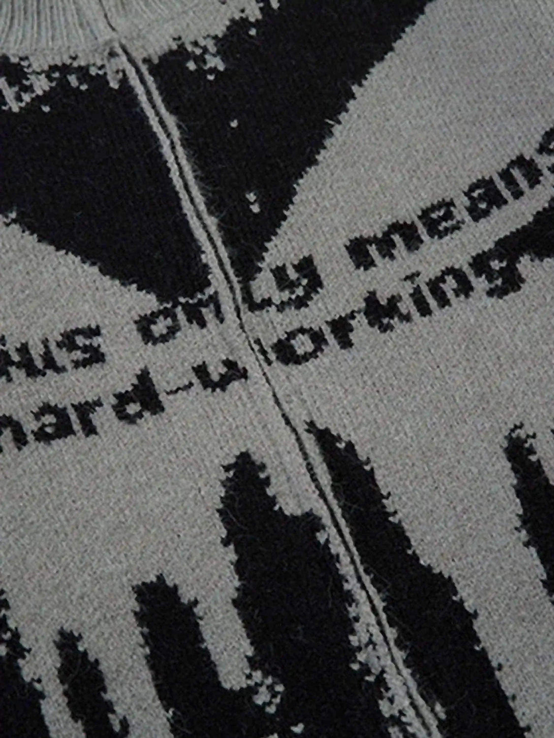 A close-up view of the TALISHKO cardigan's abstract pattern and zipper, emphasizing texture.