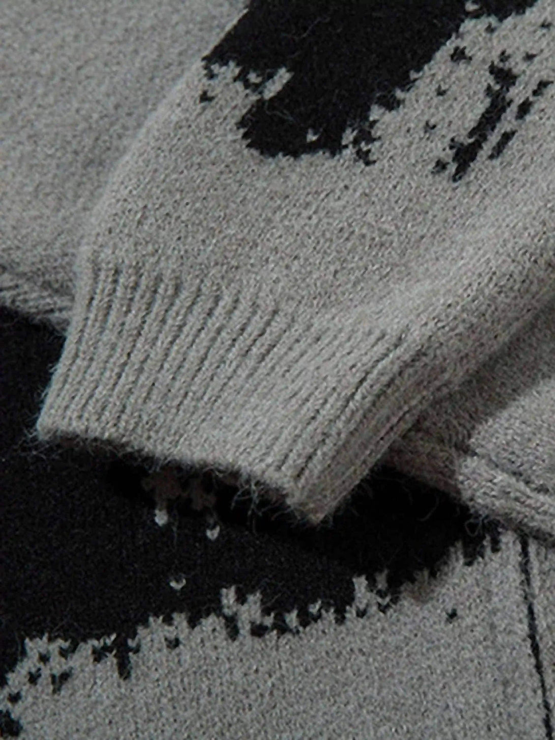 Zoomed-in view of TALISHKO cardigan sleeve, highlighting the textured abstract pattern.