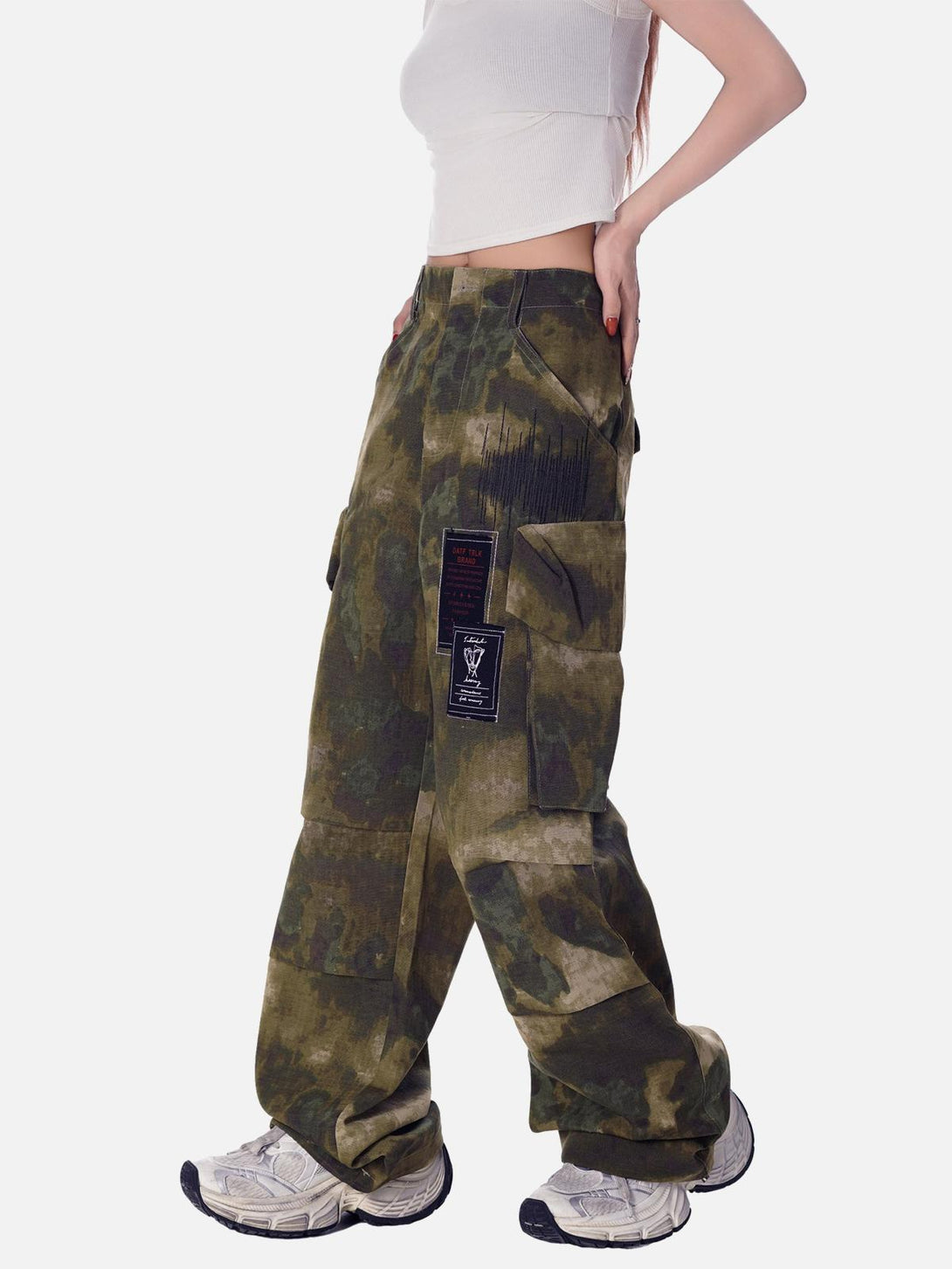 Model wearing TALISHKO camouflage pants with a stylish multi-pocket design and relaxed fit.