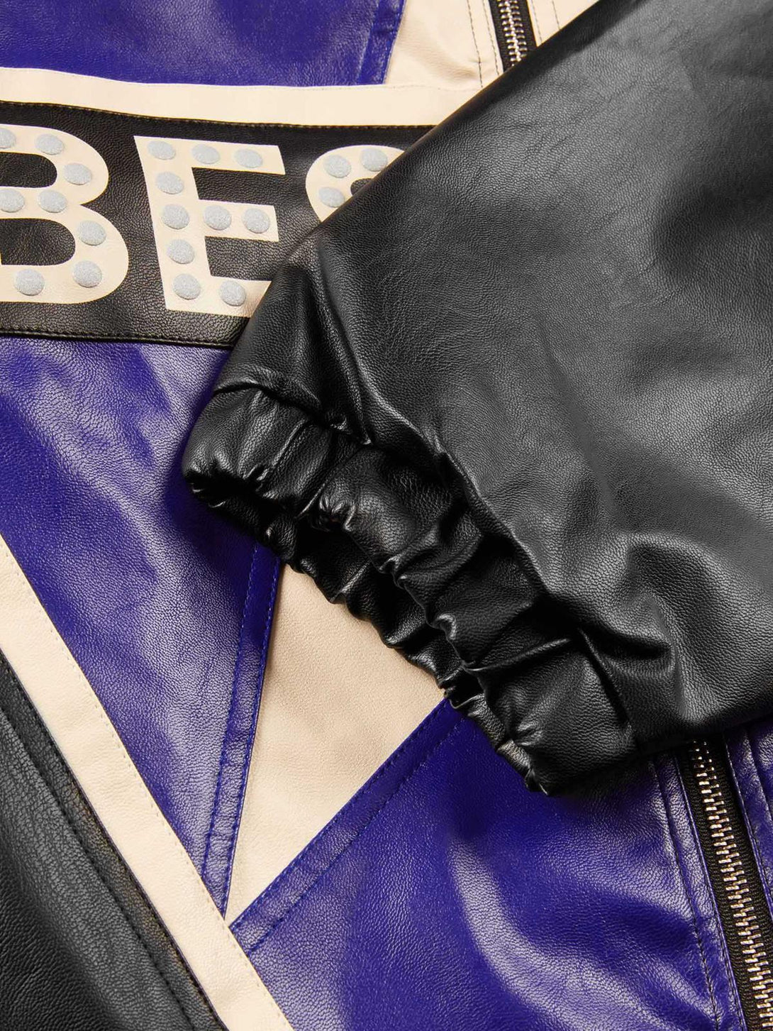 A close-up of TALISHKO's high street biker jacket, highlighting the vibrant leather details.