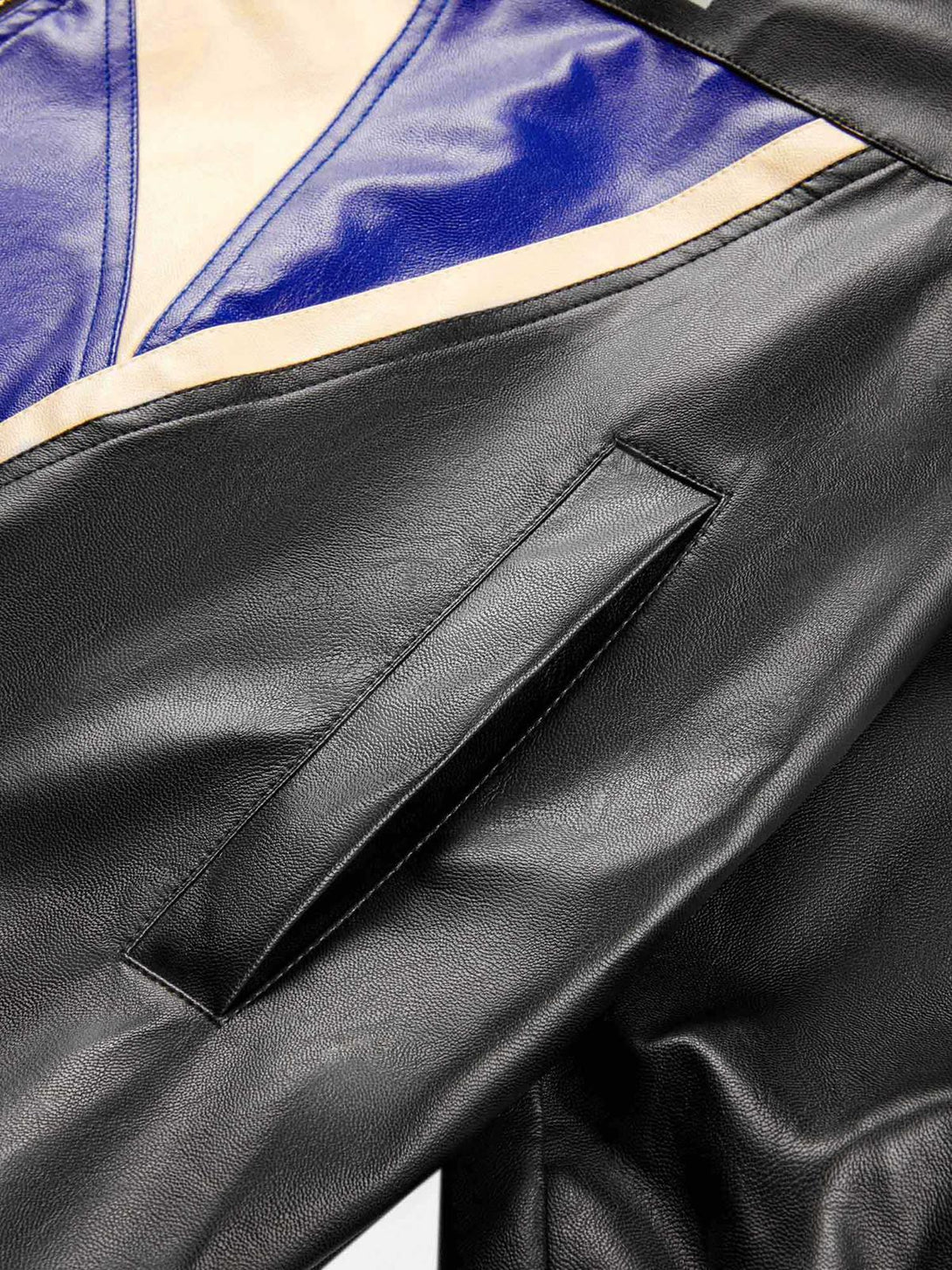 Focusing on TALISHKO's biker jacket, showcasing sleek leather and bold color contrasts.