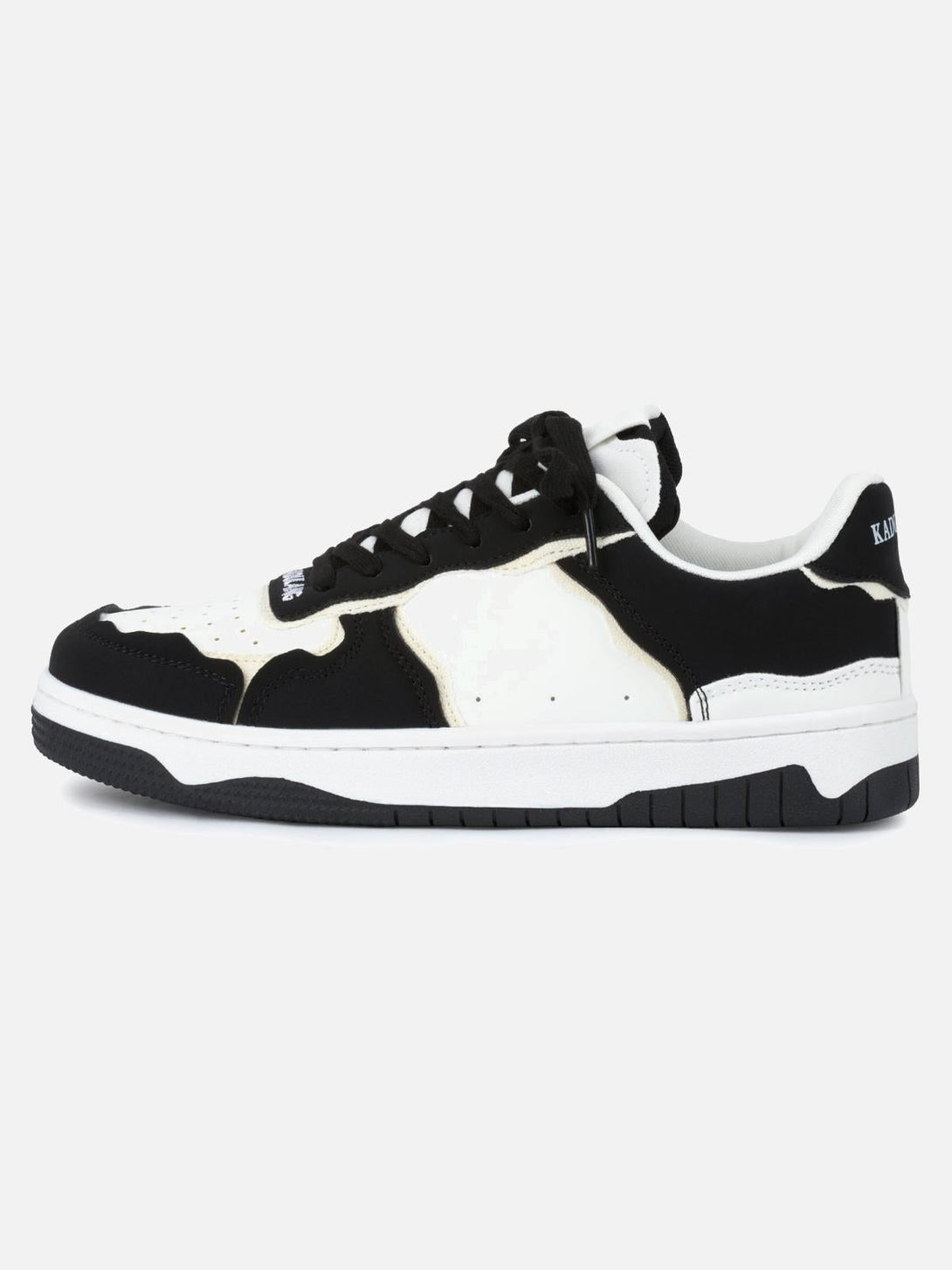 Side view of TALISHKO's black and white board casual shoes highlighting sleek design.