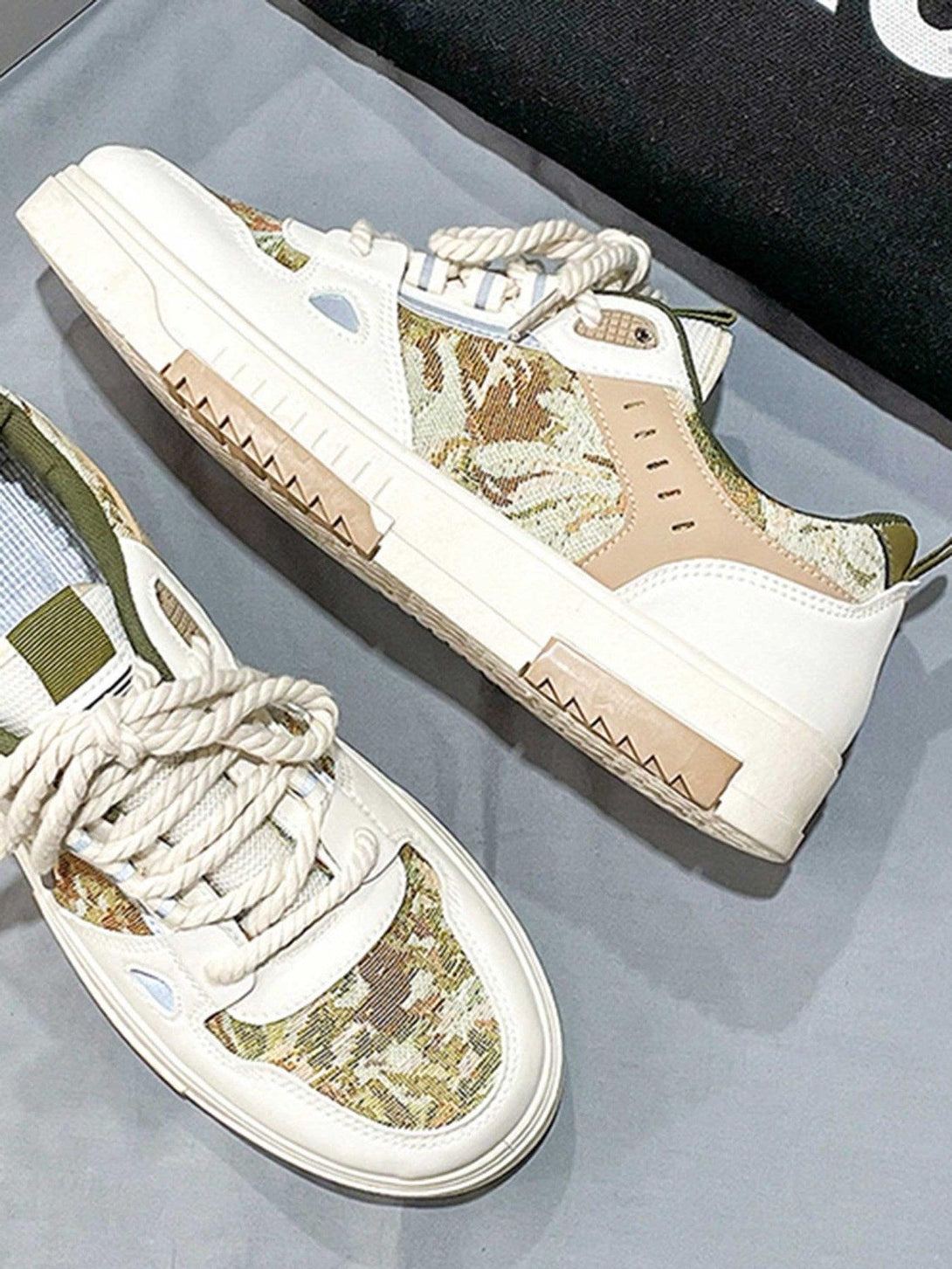 A detailed view of TALISHKO's board shoes, showcasing camo patterns and sturdy construction.