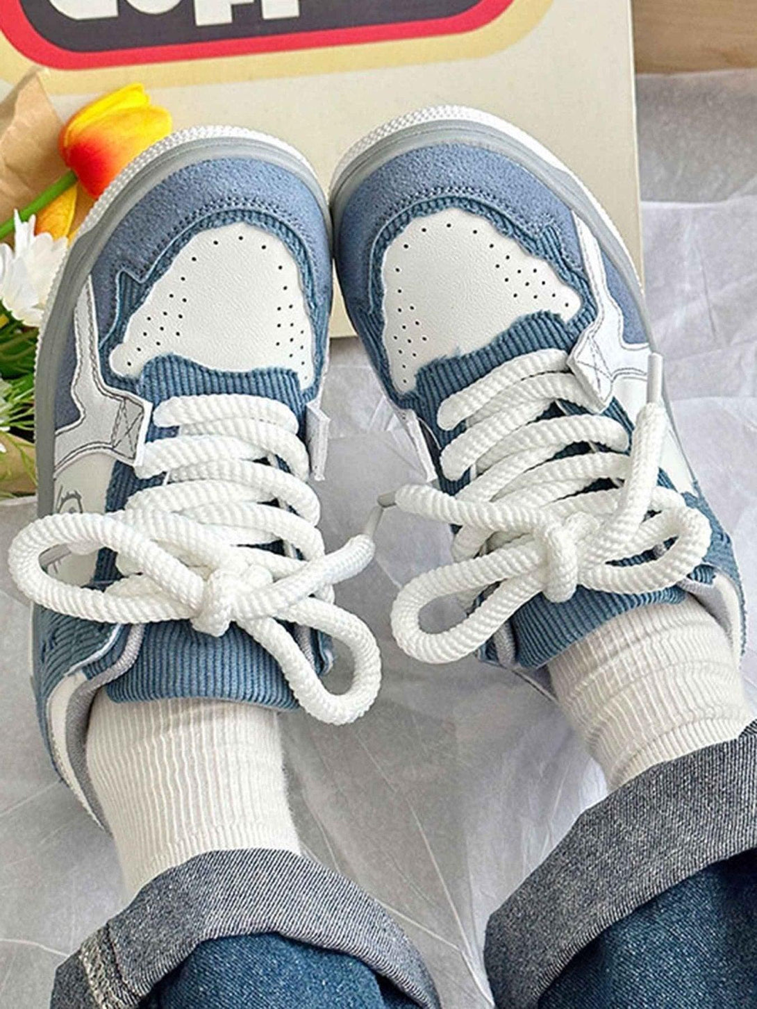 TALISHKO board shoes in blue and white, laced up with thick soles for a stylish street look.