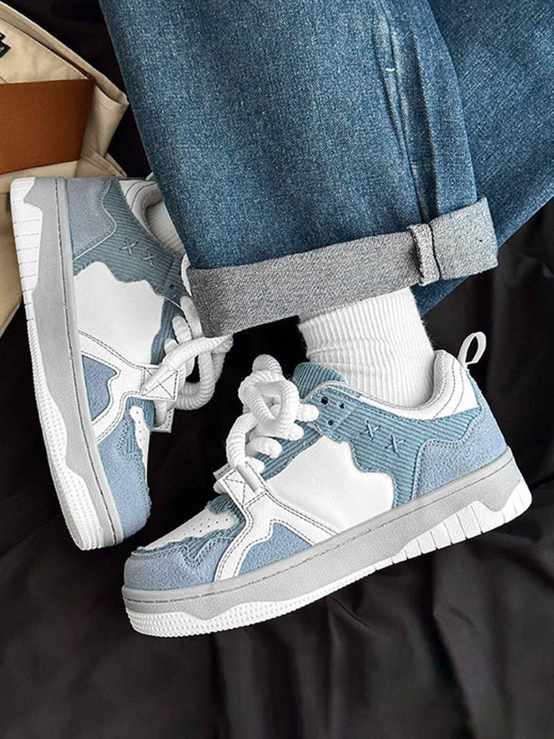 TALISHKO board shoes in blue and white, paired with denim, highlight a trendy street style.