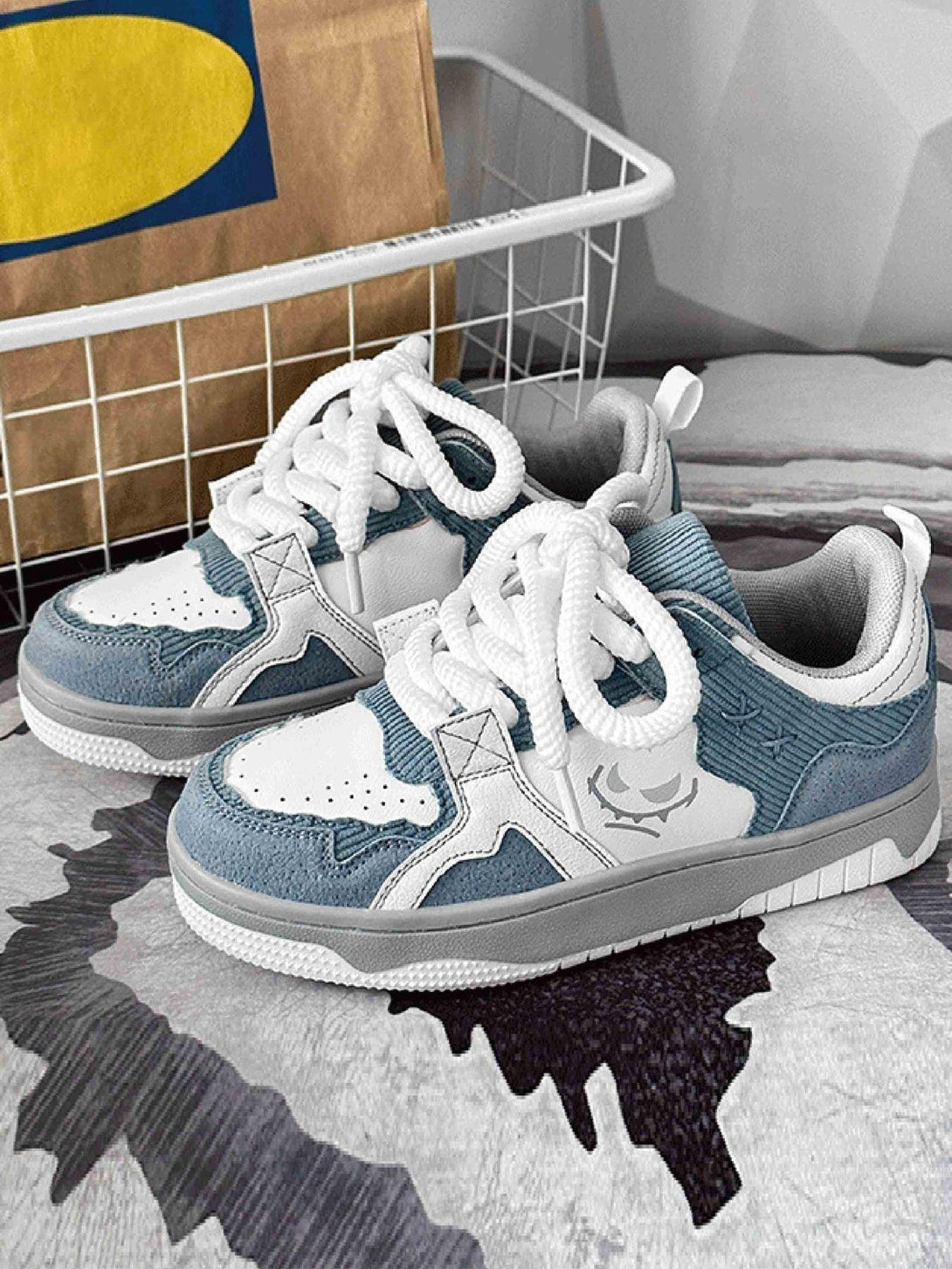 TALISHKO board shoes in blue and white, highlighting thick soles and textured fabric details.