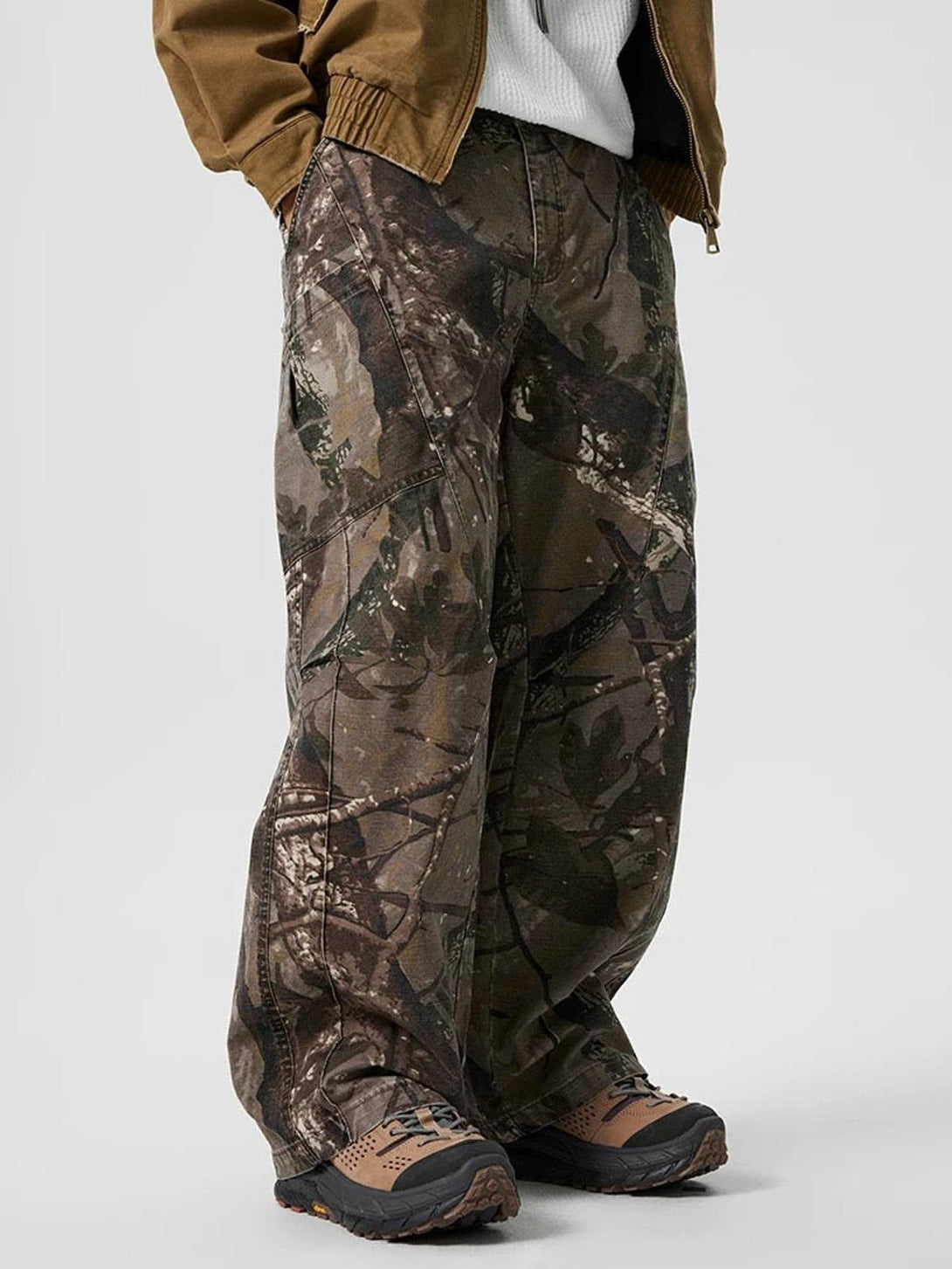 Relaxed camouflage casual pants by TALISHKO, modeled with rugged outdoor footwear.