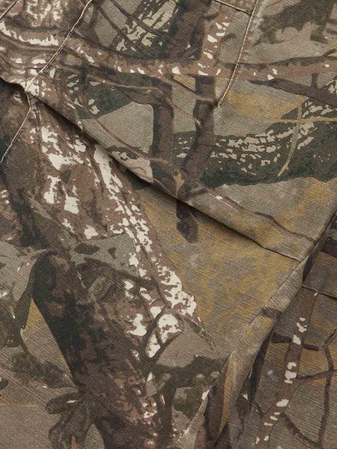 Texture and pattern showcased on TALISHKO camouflage pants, highlighting intricate design details.