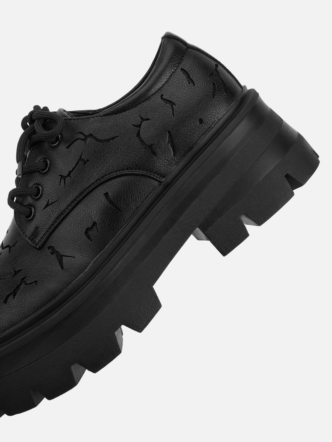A detailed look at TALISHKO crackle leather shoes, focusing on the chunky sole and texture.