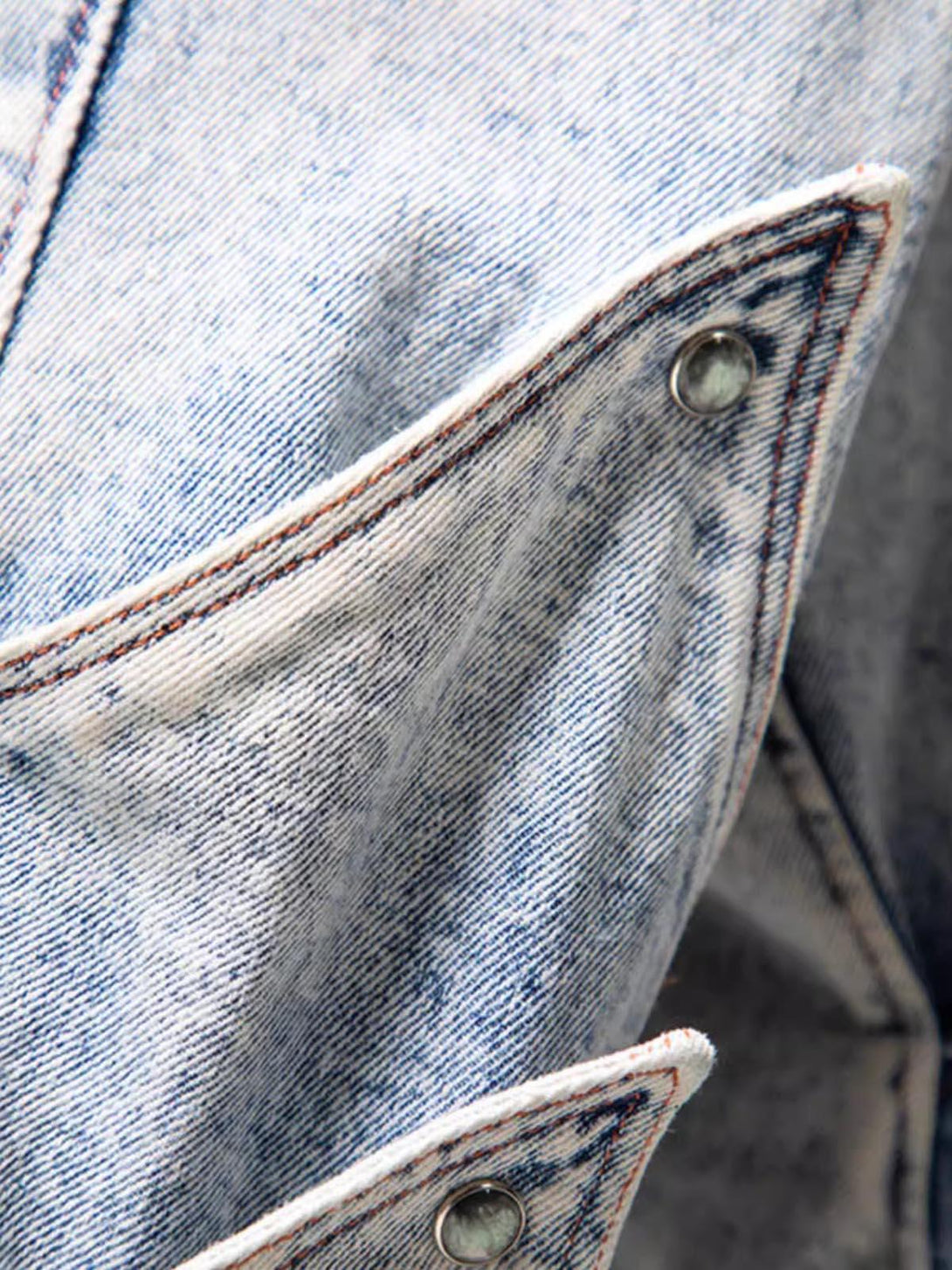 A detailed view of TALISHKO's deconstructed jeans pocket, showcasing unique stitching and design.