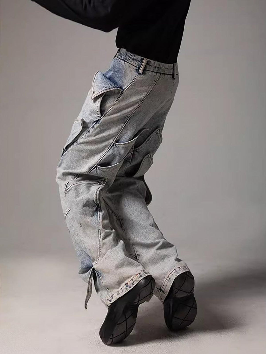 Side view of TALISHKO deconstructed jeans featuring bold geometric details and urban flair.